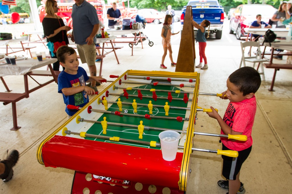 Kids playing with a foosball table
